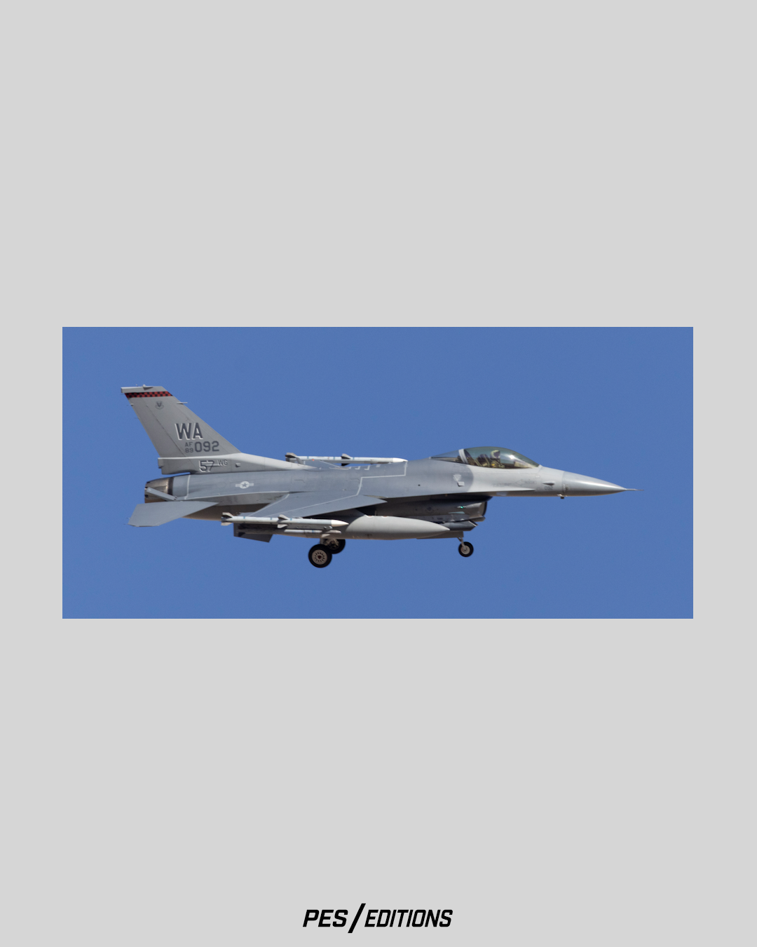 Profile view of a U.S. Air Force F-16CM Fighting Falcon, Tail 89-092, carrying the 57th Wing flagship '57 WG' markings from Nellis AFB, captured in a clean landing profile against a solid blue sky by Phil Schmauder for PES Editions.