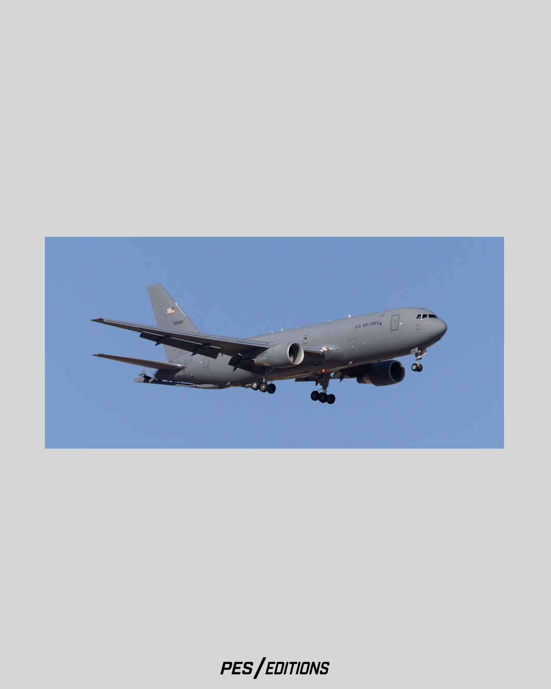 Sleek profile photograph of a modern Boeing KC-46A Pegasus refueling tanker aircraft, on final landing approach against a deep blue sky by aviation photographer Phil Schmauder for PES Editions.