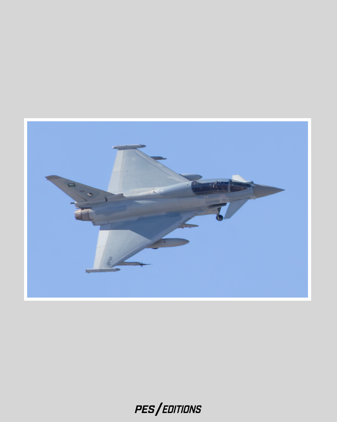 A Eurofighter Typhoon banking aggressively, revealing its large delta wing shape and forward canards against the blue sky.
