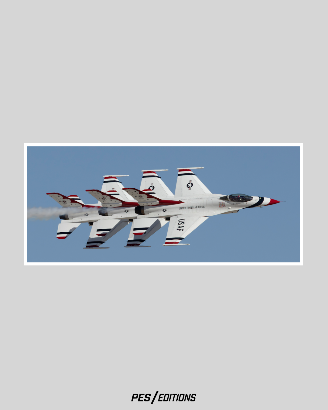 Three U.S. Air Force Thunderbirds F-16 jets flying in a tight echelon formation against a blue sky, with their red, white, and blue vertical stabilizers perfectly aligned in a diagonal row.